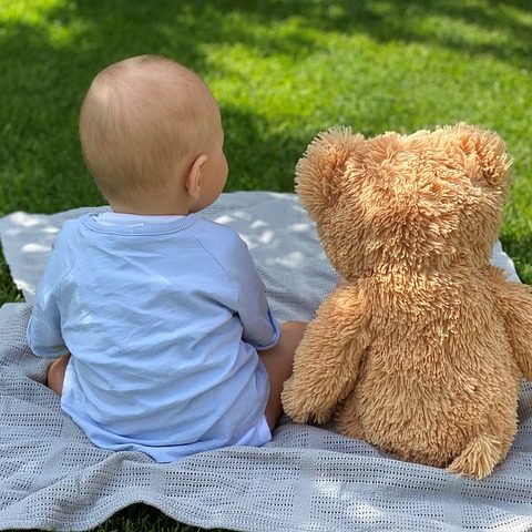 Teddy bear and child